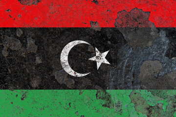 Libya flag on a damaged old concrete wall surface