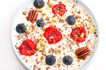 Oatmeal porridge with raspberries and blueberries. Vitamin breakfast