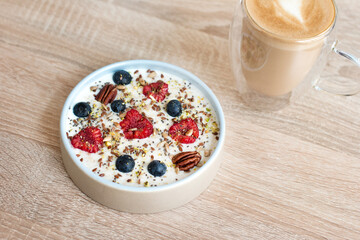 Oatmeal porridge with raspberries and blueberries. Vitamin breakfast