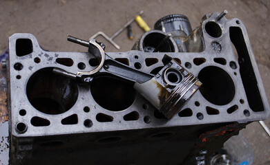 An auto mechanic is working on a car engine in a mechanics garage. Repair service. authentic...