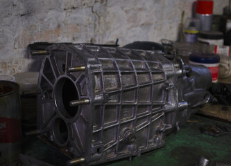 An auto mechanic is working on a car engine in a mechanics garage. Repair service. authentic close-up shot. VAZ 2106