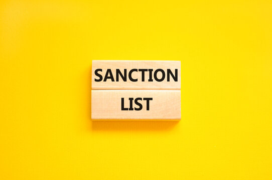 Sanction list symbol. Wooden blocks with concept words Sanction list on beautiful yellow background. Business political sanction list concept. Copy space.
