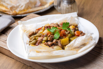 Traditional Turkish food; Meat with vegetables wrapped in greaseproof paper, kebab (Turkish name; Sebzeli kagit kebabi)