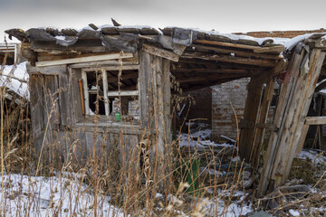 A part of an outbuilding destroyed by the explosion near a residential one-story building.