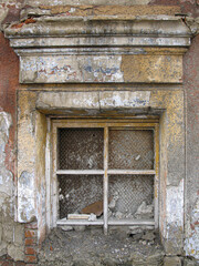 The window of an old house abandoned by residents due to the danger of further residence.