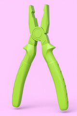 Hand tool pliers for repair and installation on pink monochrome background