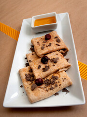 Delicious pancakes with honey, chocolate and cherries.