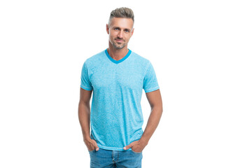 Obraz premium Happy handsome caucasian guy smiling in casual style holding hands in pockets isolated on white