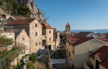 Obraz premium Street view and bell tower of St Michael's church in the old town of Omis, Croatia