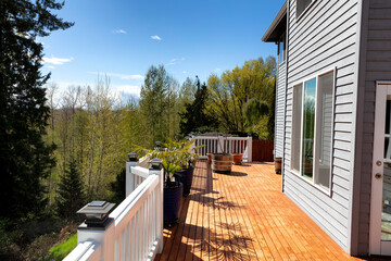 Home outdoor cedar wood deck just freshly stained during early spring season