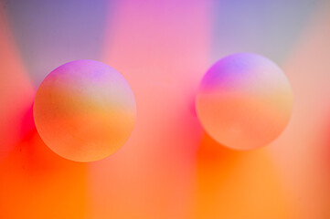 Blurred background, two balls in pink and purple.