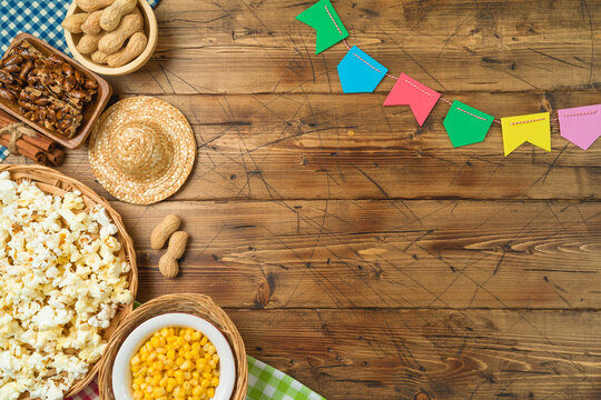 Festa Junina party background with popcorn, peanuts and traditional sweets. Brazilian summer harvest festival concept. Top view, flat lay