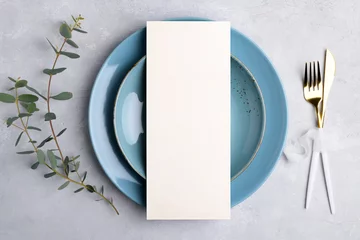 Fotobehang Vertical menu card mockup with festive wedding or birthday table setting with golden cutlery, eucalyptus, blue ceramic plate on grey background. Restaurant menu concept. Flat lay, top view © Anna Fedorova