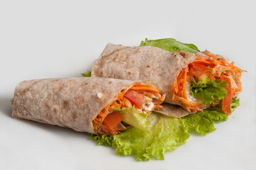 Vegetables with sour cream, wrapped in bread of pita  on a white background