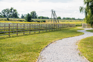 Beautiful day on the farm. Countryside landscape, rural farm and wooden fence