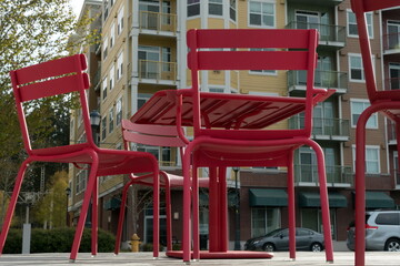Red chairs at park in front of multistore building in Town Center