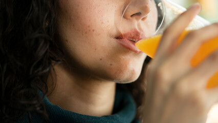 Young woman drinking orange juice - obrazy, fototapety, plakaty