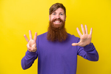 Redhead man with beard isolated on yellow background counting eight with fingers