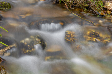 Fresh color clean water in mountains creek with color stones