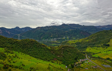 Antisana volcano in Ecuador, view from village Papallacta, snow on the top and green forests...