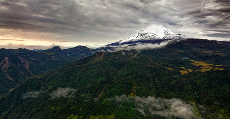 Obraz na płótnie Canvas Antisana volcano in Ecuador, view from village Papallacta, snow on the top and green forests around, landscape photography, stratovolcano