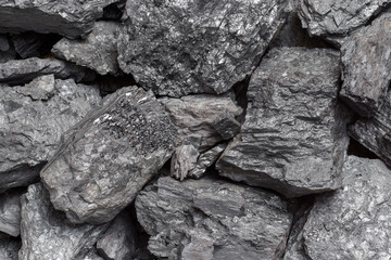A heap of bituminous coal stone rock lumps. Non-renewable energy source. Natural fuel
