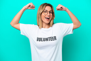 Young volunteer Uruguayan woman isolated on blue background doing strong gesture