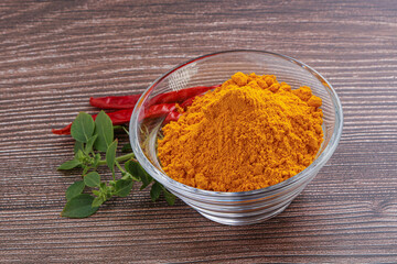 Yellow vibrant curcuma powder in the bowl