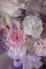 Beautiful composition with peonies and roses in a purpl box on pink chair. Bouquet of tenders peonies a girl for mother's day, valentine's day, Woman's day 8 march.