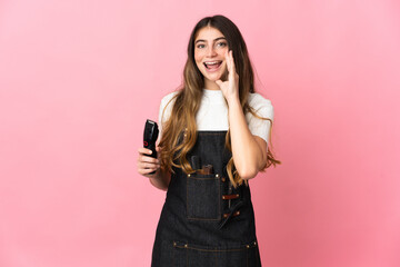 Young hairdresser woman isolated on pink background shouting with mouth wide open