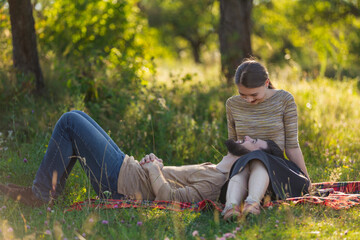 young couple sitting in nature and relaxing