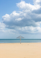 umbrella on a desert cloudy beach