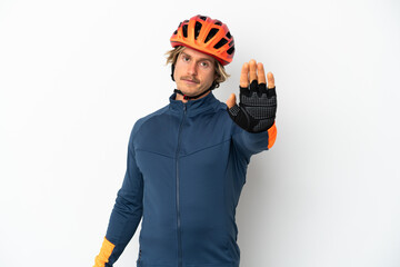 Young blonde cyclist man isolated on white background making stop gesture - obrazy, fototapety, plakaty