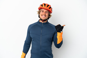 Young blonde cyclist man isolated on white background pointing to the side to present a product