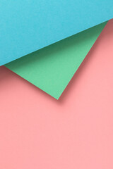 Paper background with turquoise, blue and pink pastel colors.