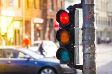 Pedestrian traffic light on the street junction in the city with beautiful bokeh, with cars and...