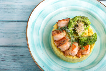 Ptitim with curry sauce shrimp and broccoli. Serving a restaurant menu dish