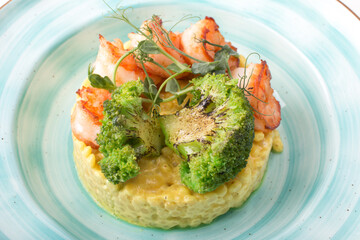 Ptitim with curry sauce shrimp and broccoli. Serving a restaurant menu dish