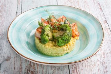 Ptitim with curry sauce shrimp and broccoli. Serving a restaurant menu dish