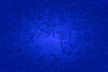 Royal blue background with old vintage texture grunge, deep sapphire blue stone or rock wall with spotlight center and dark border, rich fancy background color