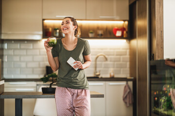 Woman Enjoying Her Morning Smoothie At Home