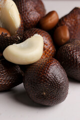 closeup, Salak seeds or snake fruit with peeled flesh isolated on a gray background