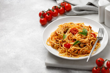 Mediterranean cuisine. Pasta with mussel, basil  and tomato sauce in white plate. Copy space