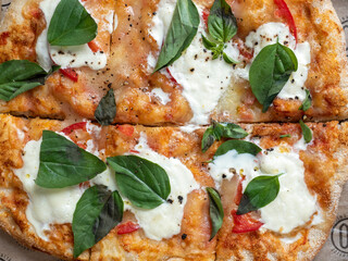 Close-up of fresh hot Roman pizza with herbs and cheese. Italian pizza, food, fast food, macrophoto, selective focus. Top view, flat lay