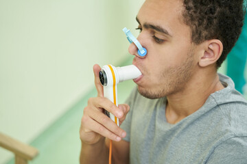 Patient checking his lung function with spirometer - obrazy, fototapety, plakaty