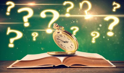 Antique pocket watch on opened old book on background.