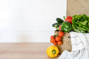 Wicker picnic box with fresh vegetables inside