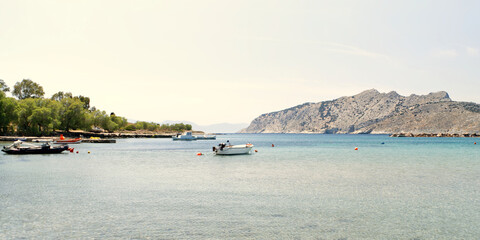 Fototapeta na wymiar Yachts in the sea on the background of the Greek island. close up