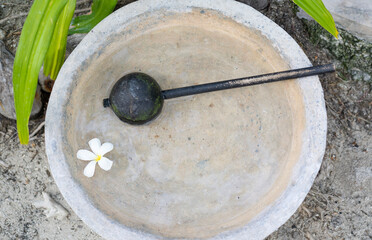 A bowl and ladle for washing feet at the entrance to a spa in the Maldives