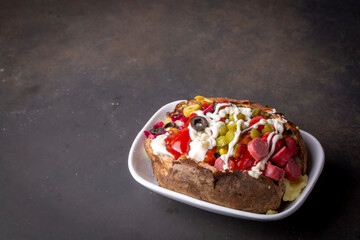 Kumpir, Turkish baked potato with cheese, corn, sausage, ketchup, mayonnaise and olives. This kumpir is traditional turkish food